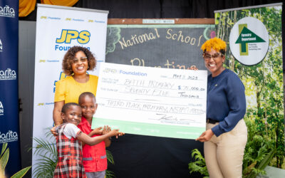 Beaming principal of the Bath Primary and Junior High School in St. Thomas, Beverly Edwards (left), is joined by students (l-r) Christina Martin and Tajaunie Derrizo, in accepting their third-place award in the primary school category of the Forestry Department’s National School Tree Planting Competition, from Head – JPS Foundation, Sophia Lewis, recently. The JPS Foundation was the major sponsor of the competition which ended in February, providing over $800,000.00 in cash awards. Despite drought conditions, students planted over 1,500 trees throughout the competition which started in September 2022.